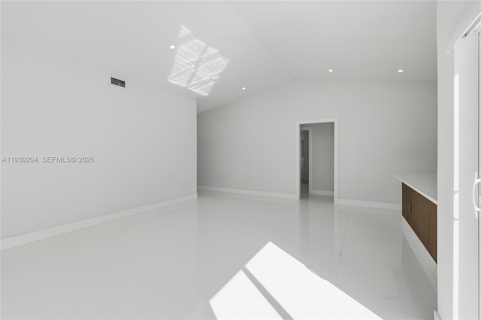 15956 Southwest 83rd Terrace Miami, FL 33193 - Photo 12 of 44 a view of a room with wooden floor and chandelier