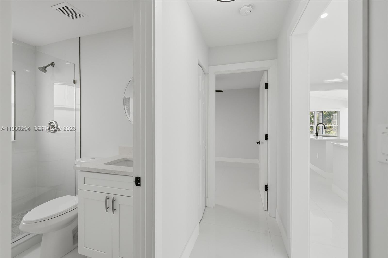 15956 Southwest 83rd Terrace Miami, FL 33193 - Photo 15 of 44 a bathroom with a granite countertop toilet and a shower