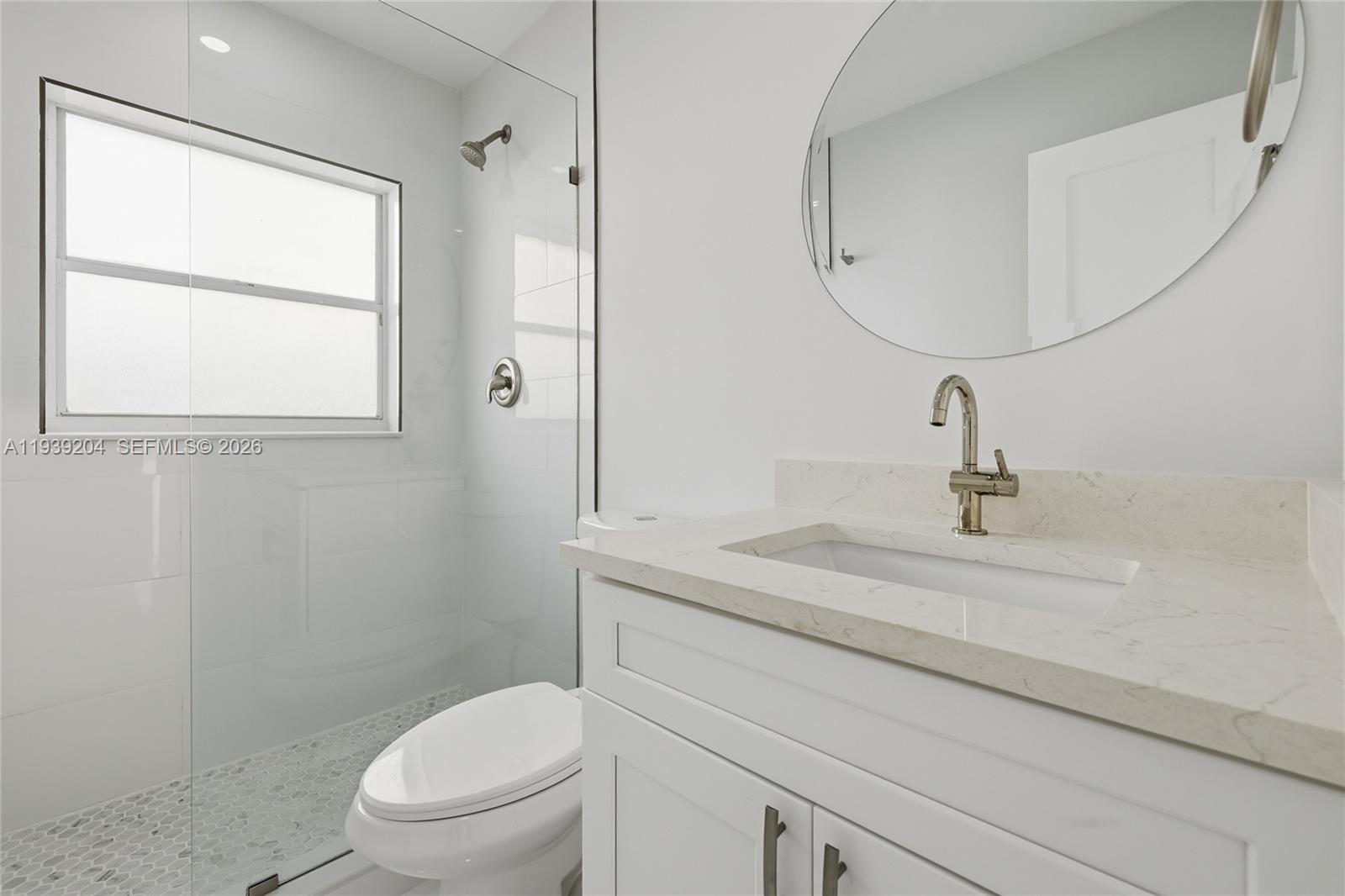 15956 Southwest 83rd Terrace Miami, FL 33193 - Photo 16 of 44 a bathroom with a sink a toilet and a mirror