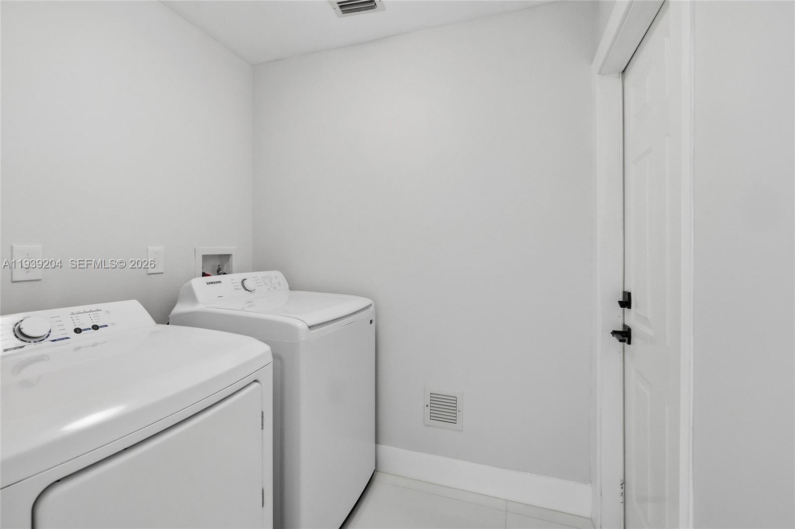 15956 Southwest 83rd Terrace Miami, FL 33193 - Photo 24 of 44 a utility room with dryer and washer