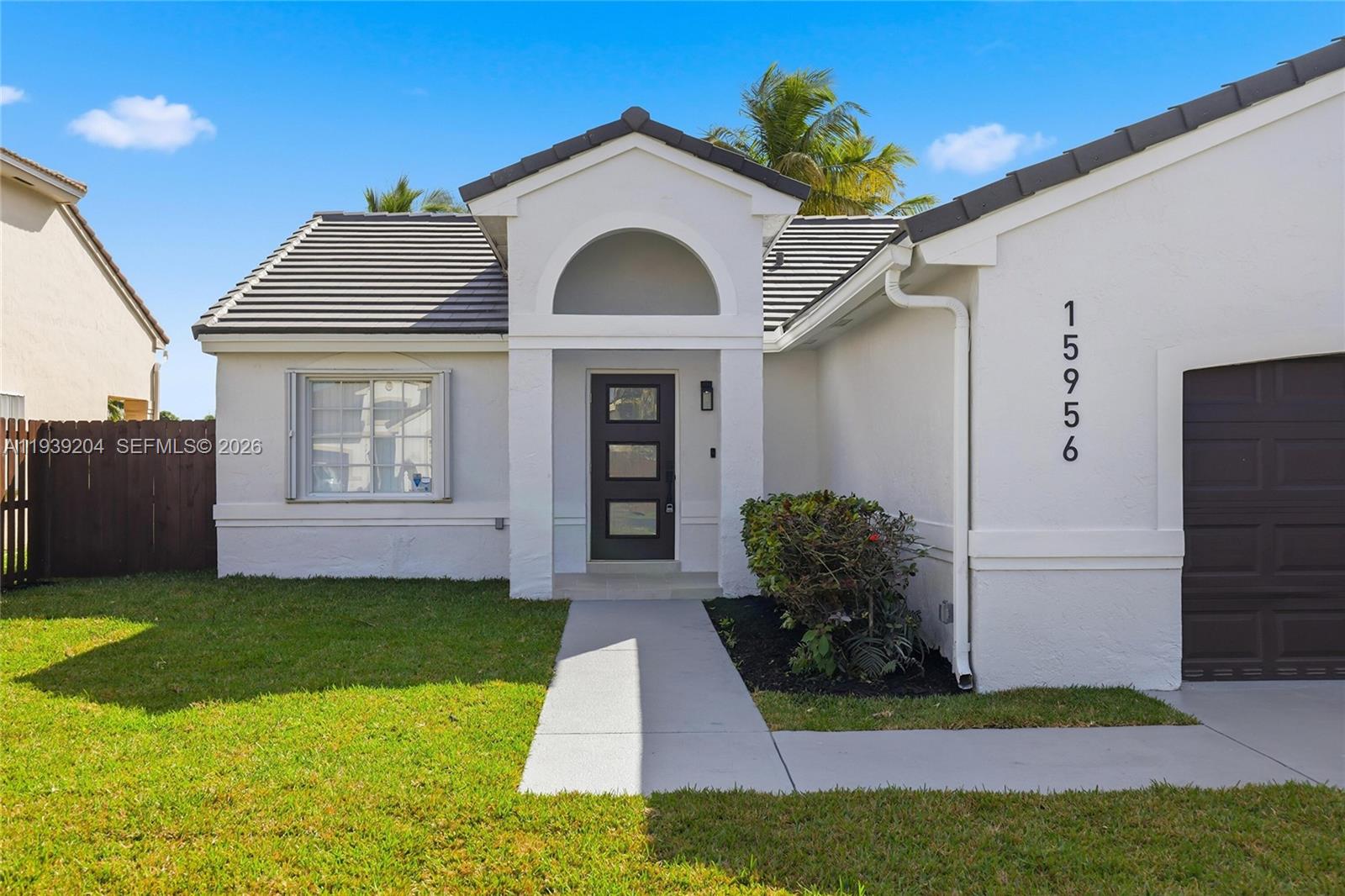 15956 Southwest 83rd Terrace Miami, FL 33193 - Photo 27 of 44 a front view of a house with garden