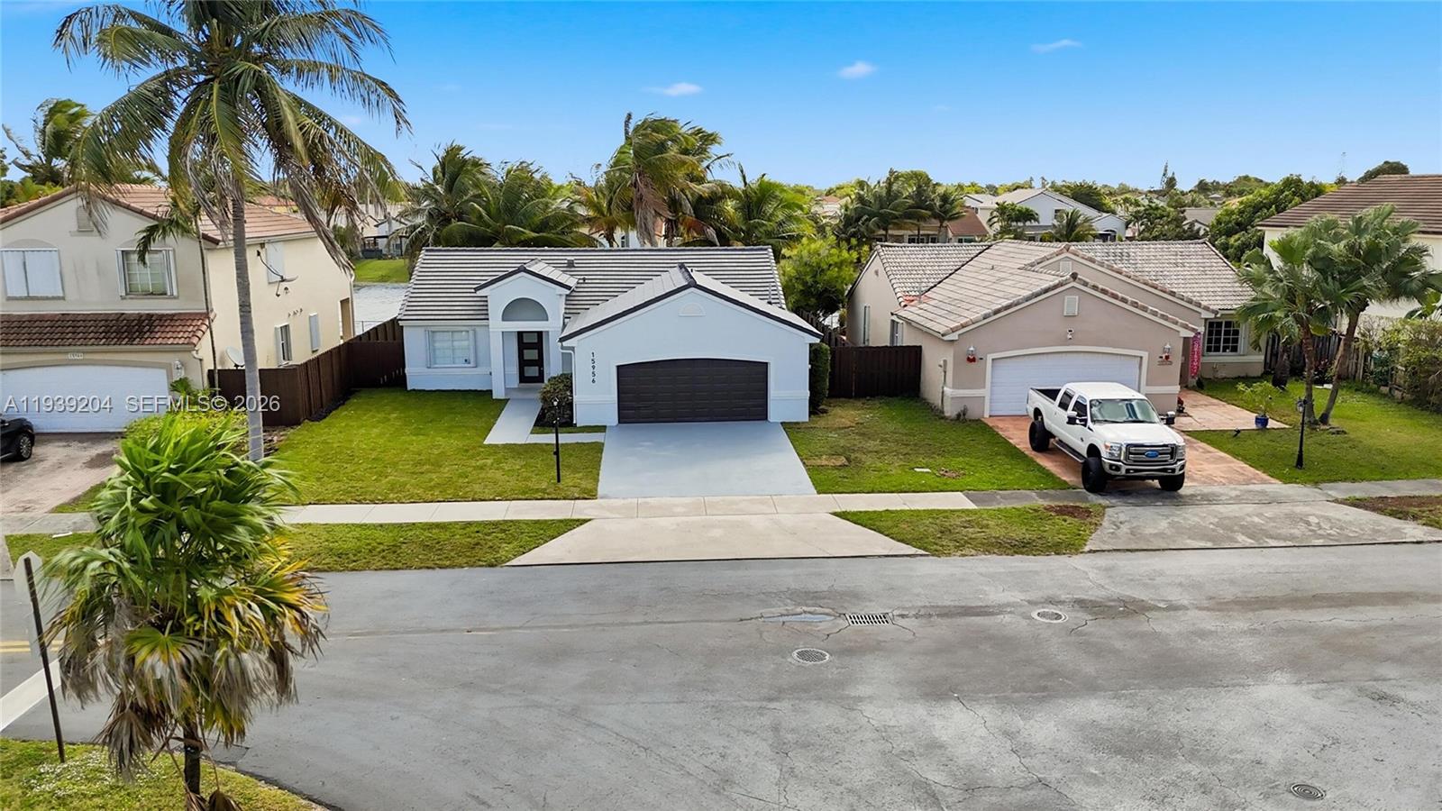 15956 Southwest 83rd Terrace Miami, FL 33193 - Photo 30 of 44 a view of house with garden and tall tress