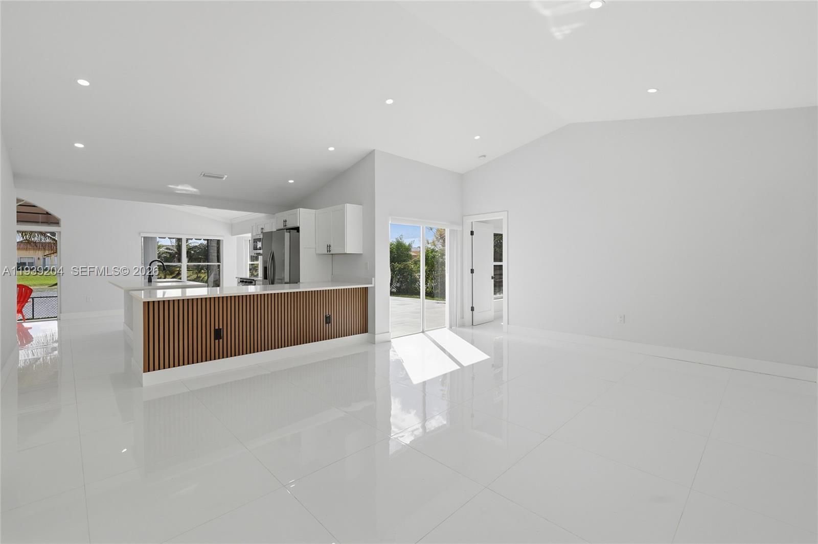 15956 Southwest 83rd Terrace Miami, FL 33193 - Photo 3 of 44 a living room with kitchen island and furniture