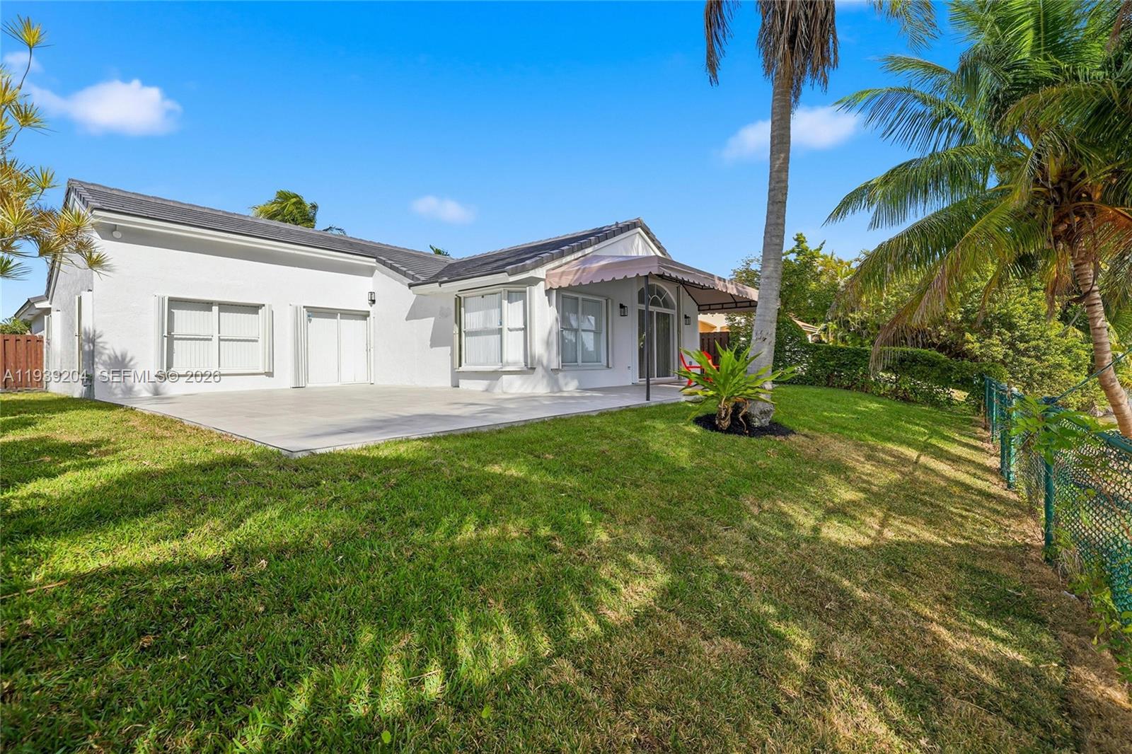15956 Southwest 83rd Terrace Miami, FL 33193 - Photo 32 of 44 a front view of a house with a yard
