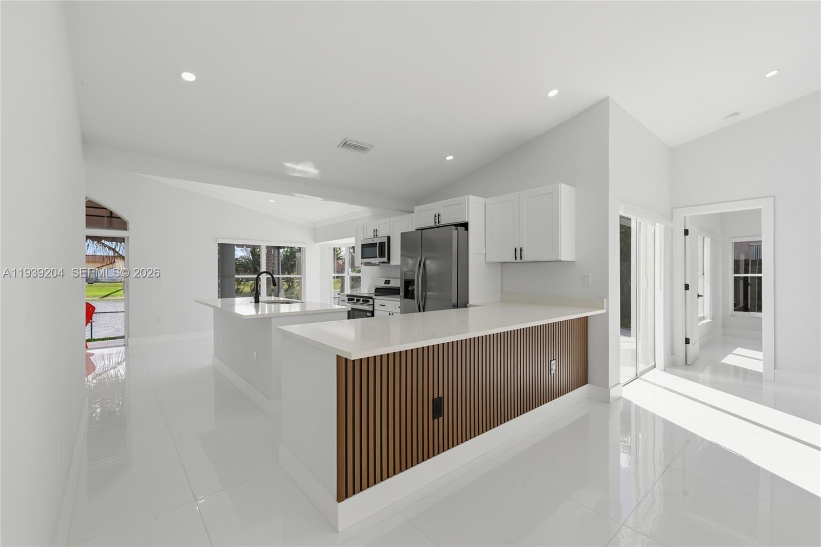 15956 Southwest 83rd Terrace Miami, FL 33193 - Photo 5 of 44 a large kitchen with stainless steel appliances a sink and cabinets