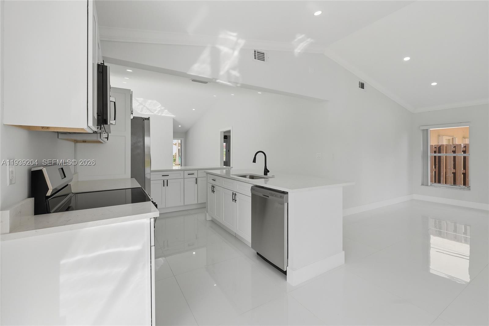15956 Southwest 83rd Terrace Miami, FL 33193 - Photo 7 of 44 a kitchen filled with white cabinets and white appliances