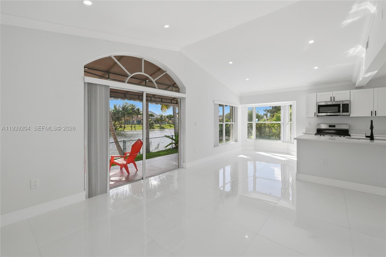 15956 Southwest 83rd Terrace Miami, FL 33193 - Photo 9 of 44 a view of a livingroom with furniture and a flat screen tv