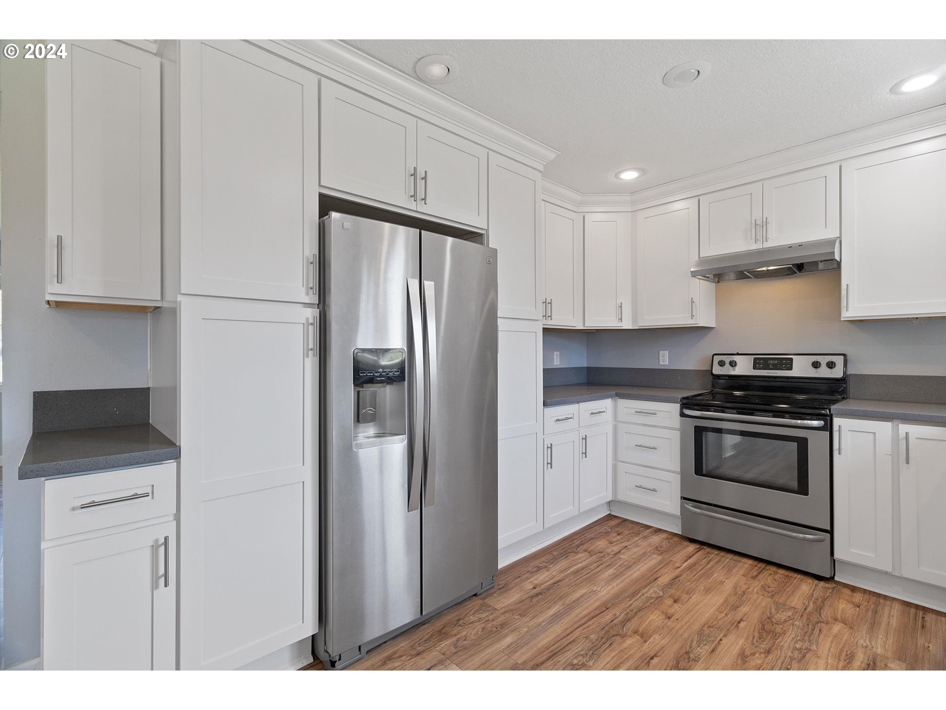 8412 Northeast 27th Avenue Vancouver, WA 98665 - Photo 15 of 36 a kitchen with stainless steel appliances a refrigerator sink and stove