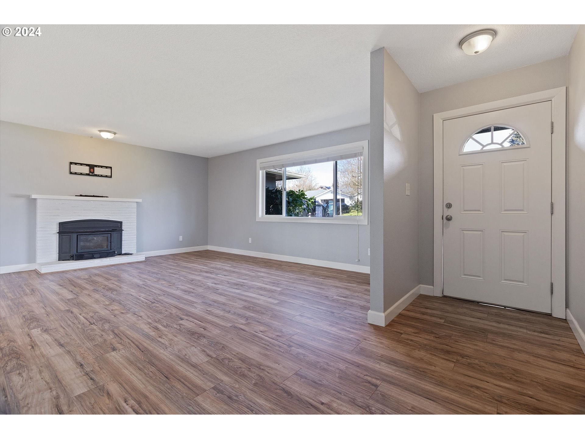 8412 Northeast 27th Avenue Vancouver, WA 98665 - Photo 5 of 36 a view of empty room with wooden floor and fireplace