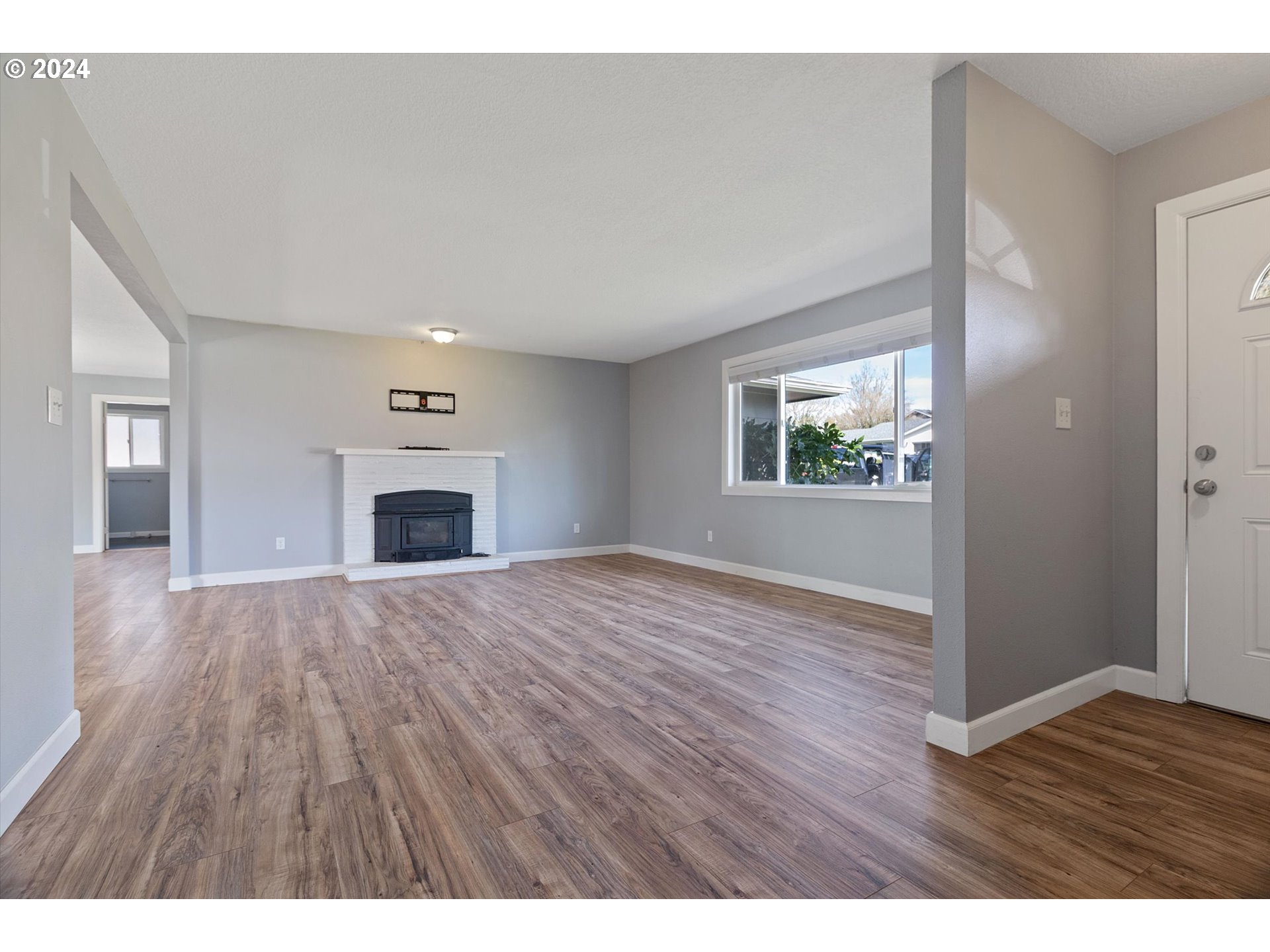 8412 Northeast 27th Avenue Vancouver, WA 98665 - Photo 6 of 36 a view of empty room with wooden floor and fireplace