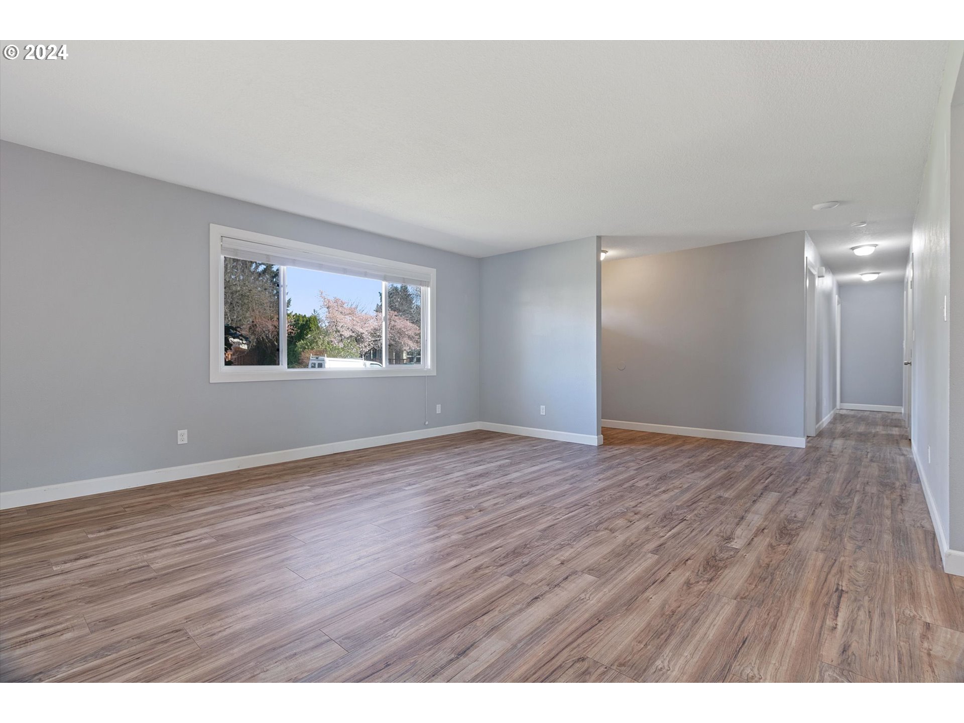8412 Northeast 27th Avenue Vancouver, WA 98665 - Photo 7 of 36 a view of an empty room with wooden floor and a window