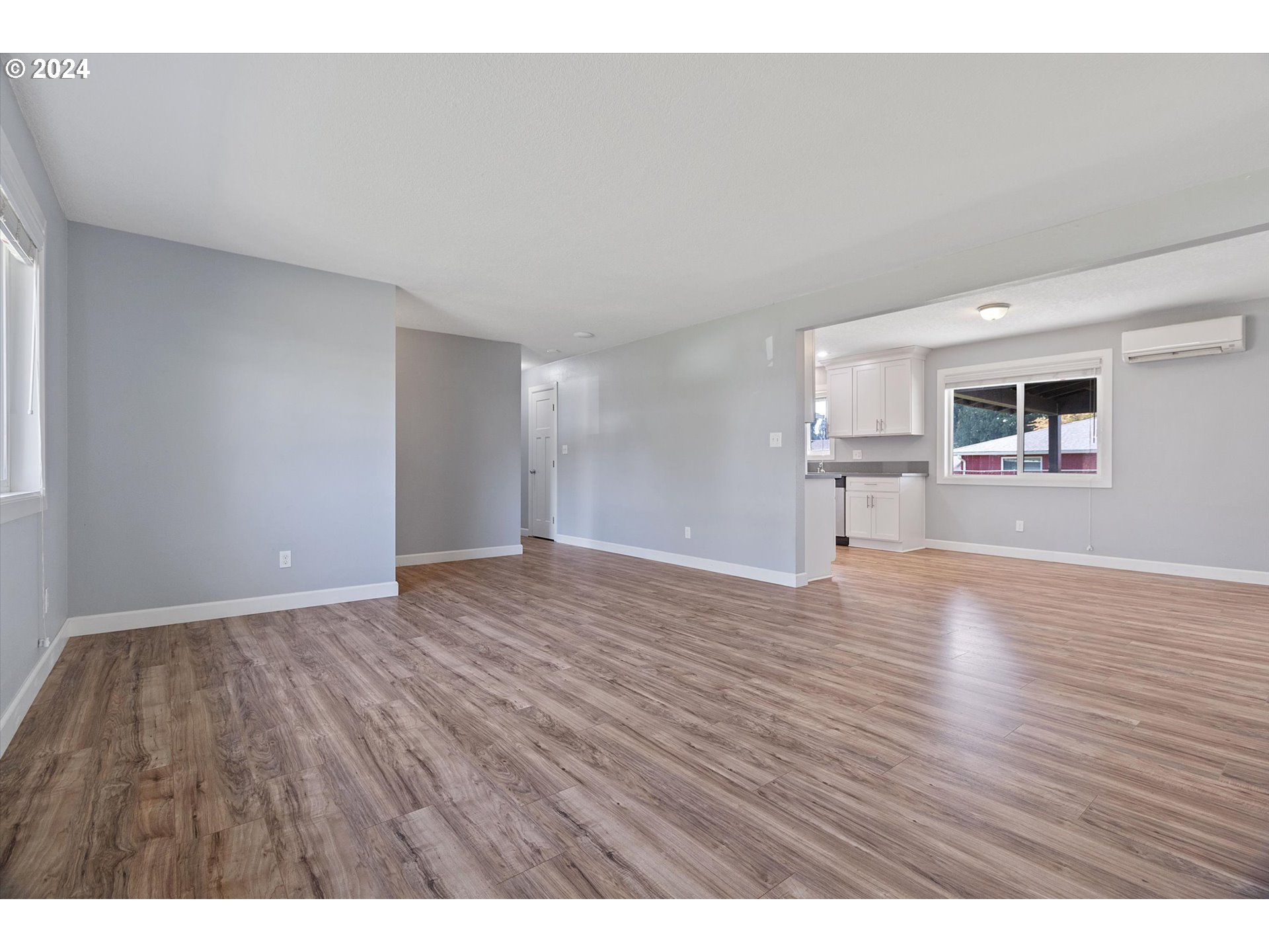 8412 Northeast 27th Avenue Vancouver, WA 98665 - Photo 8 of 36 a view of an empty room with a window and wooden floor