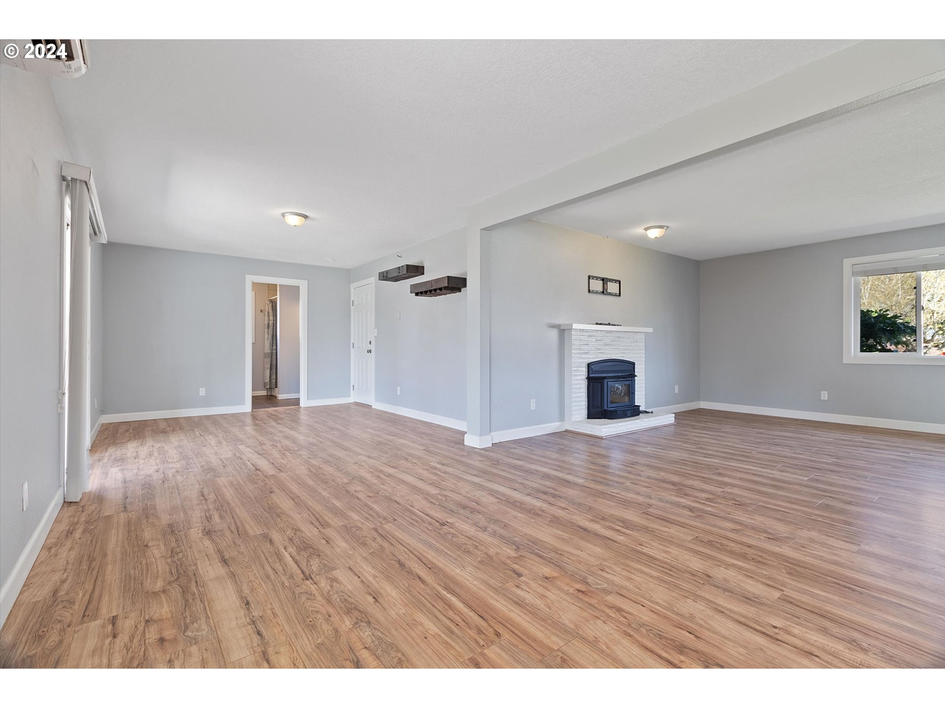 8412 Northeast 27th Avenue Vancouver, WA 98665 - Photo 9 of 36 a view of empty room with wooden floor and fireplace