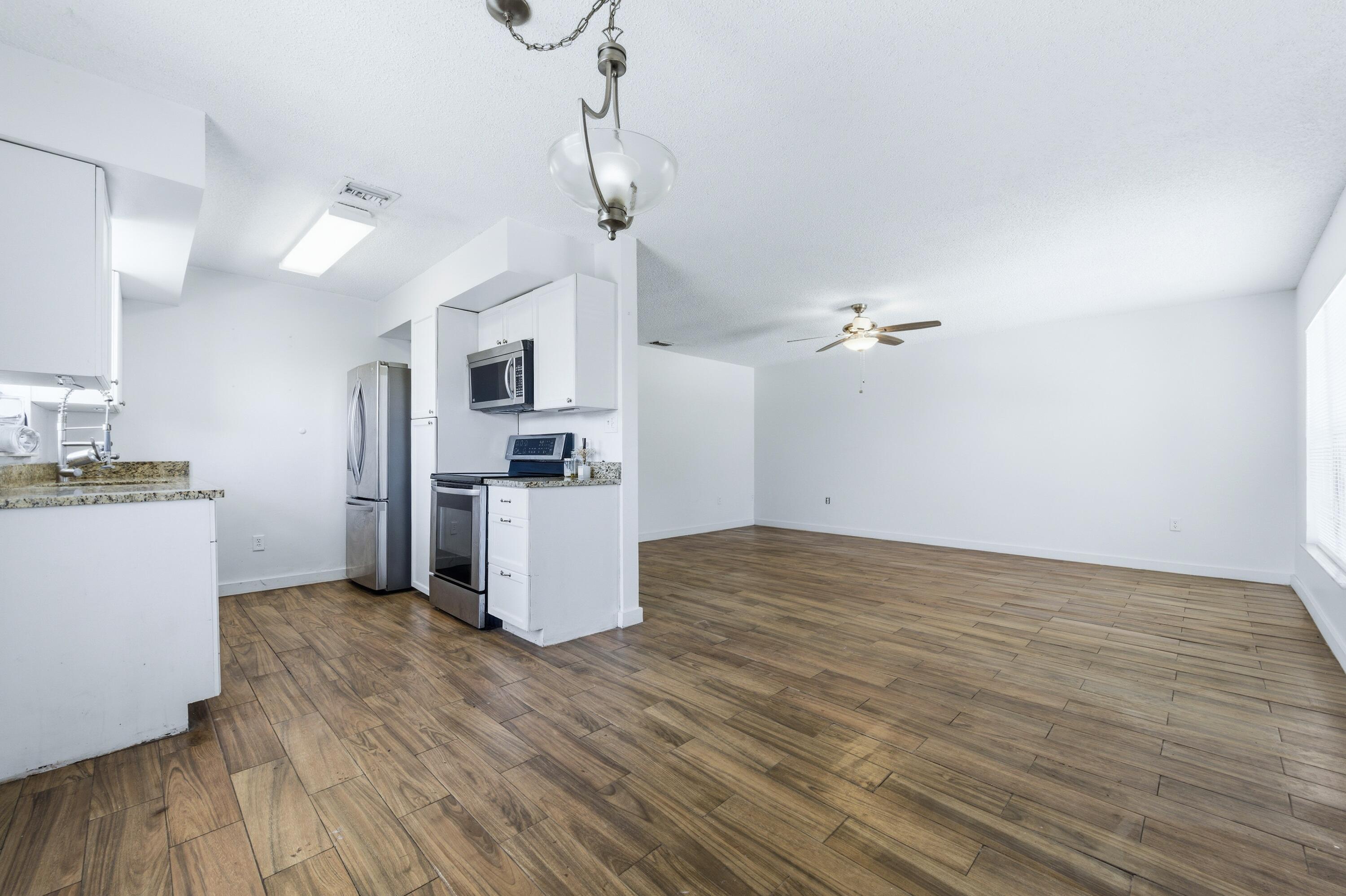 6088 Heather Street Jupiter, FL 33458 - Photo 18 of 18 a kitchen with stainless steel appliances a refrigerator and a stove top oven