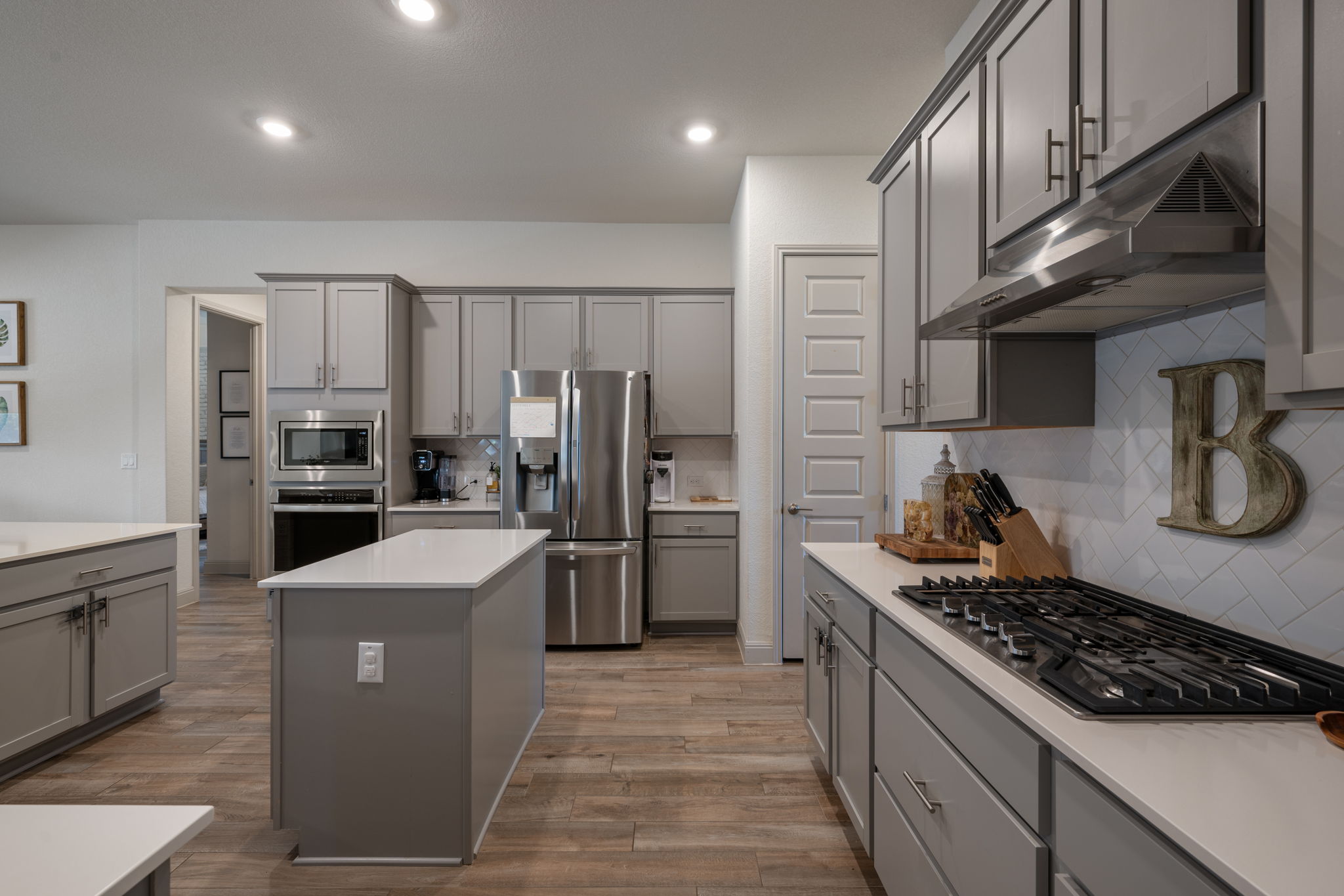 1808 Weavers Bend Georgetown, TX 78628 - Photo 11 of 30 a kitchen with stainless steel appliances a sink stove refrigerator and cabinets