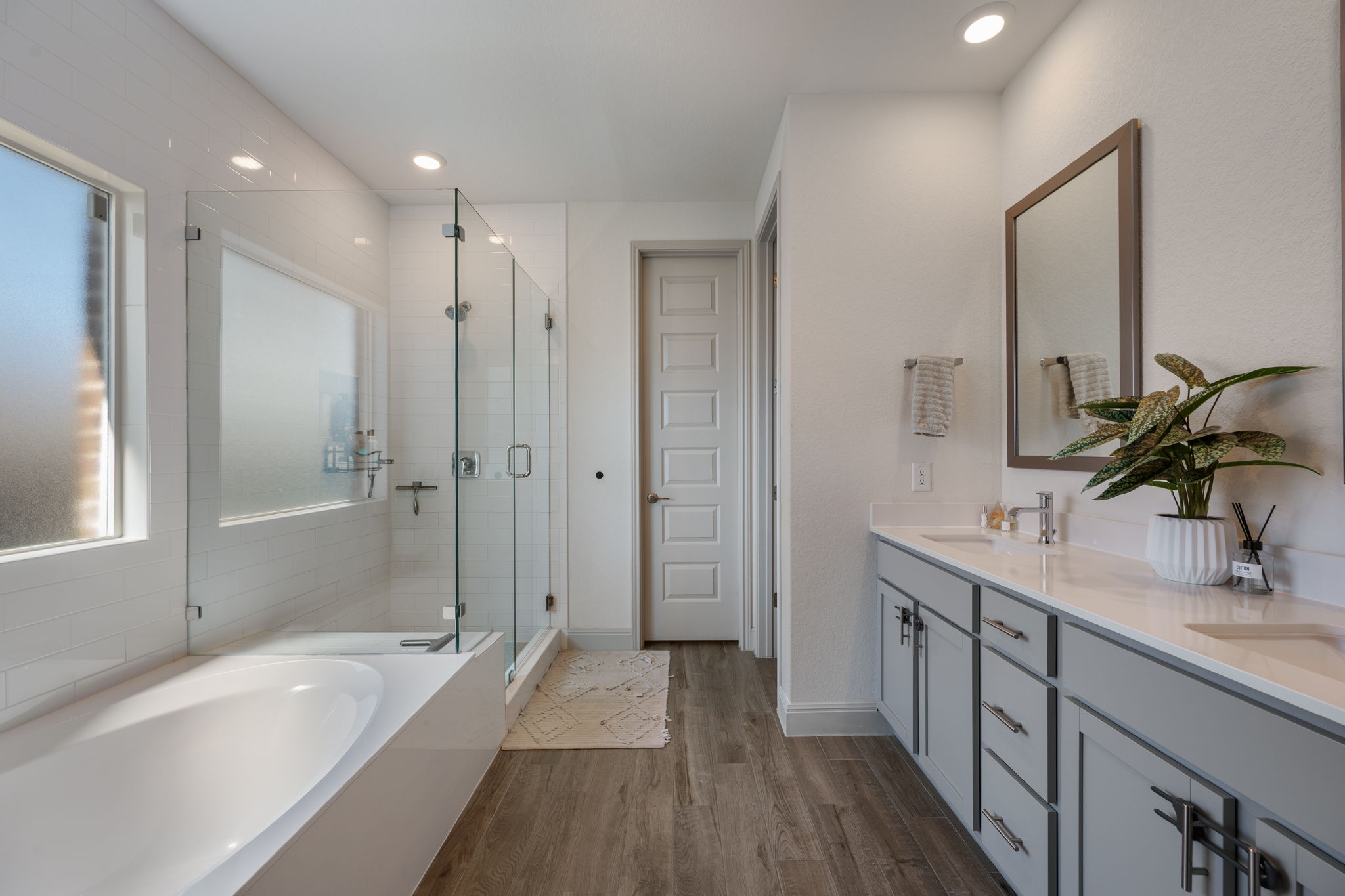 1808 Weavers Bend Georgetown, TX 78628 - Photo 16 of 30 a bathroom with a tub sink shower and two mirror