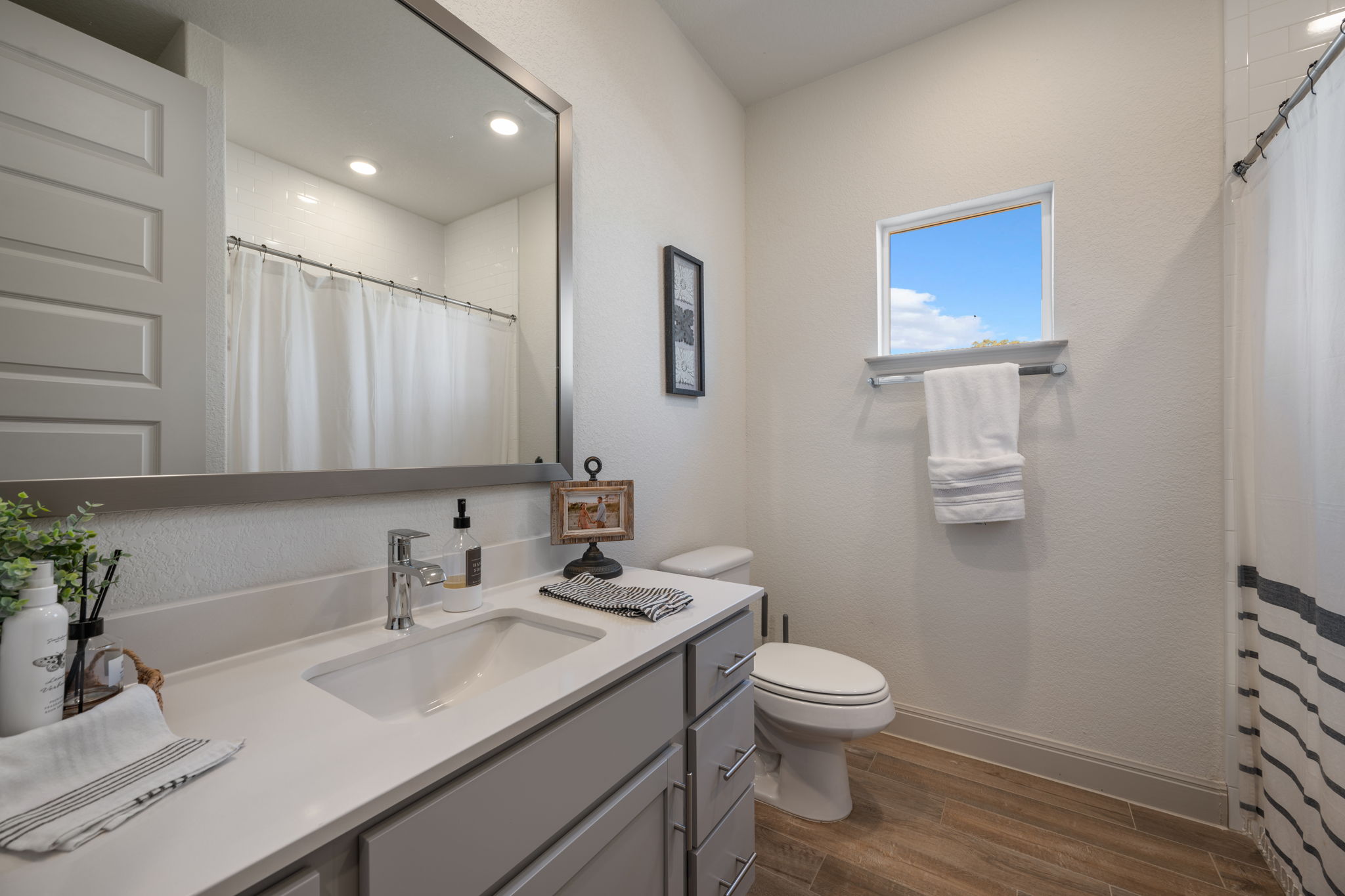 1808 Weavers Bend Georgetown, TX 78628 - Photo 19 of 30 a bathroom with a toilet a sink and mirror