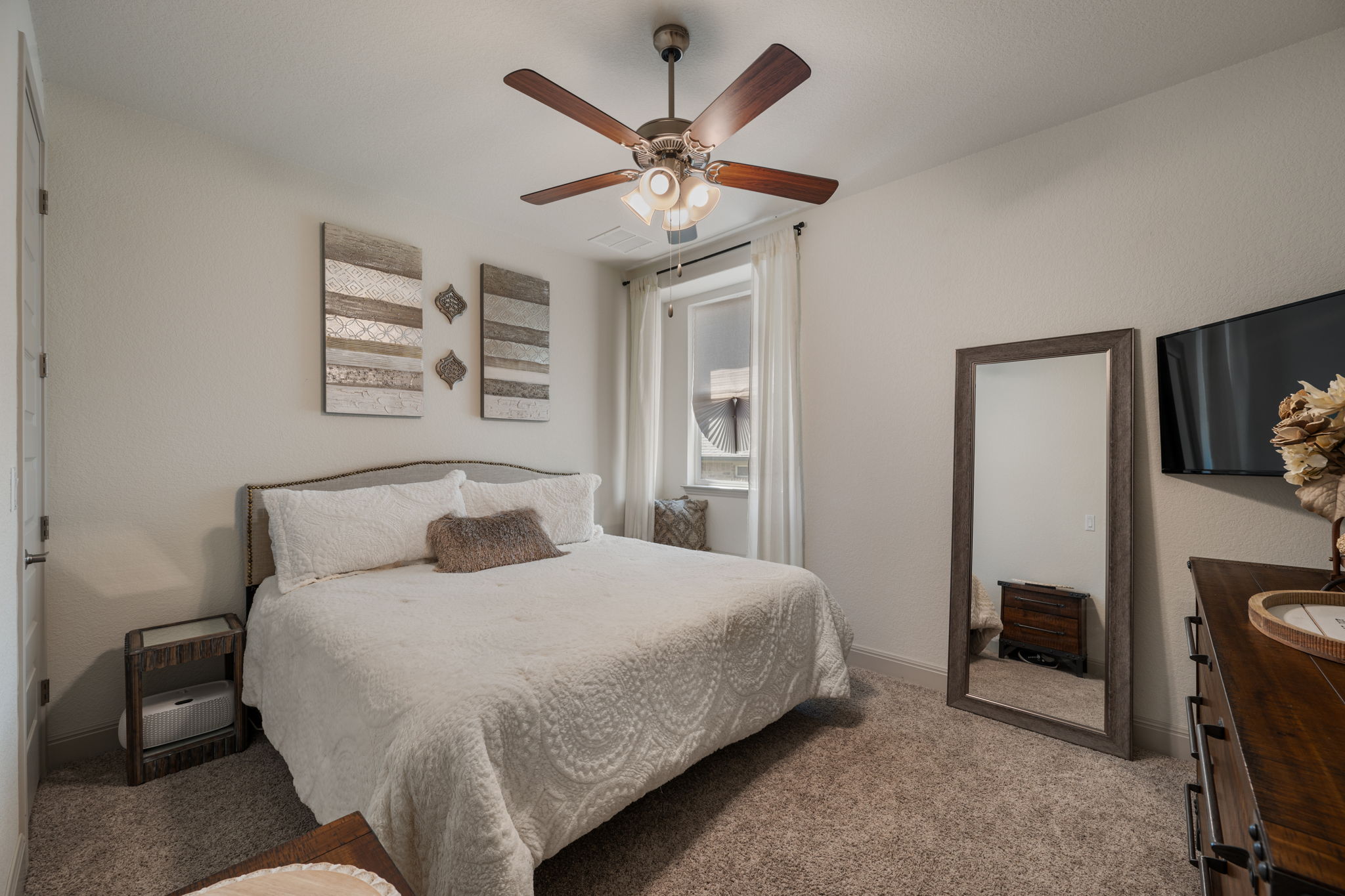 1808 Weavers Bend Georgetown, TX 78628 - Photo 21 of 30 a bedroom with a bed and a ceiling fan