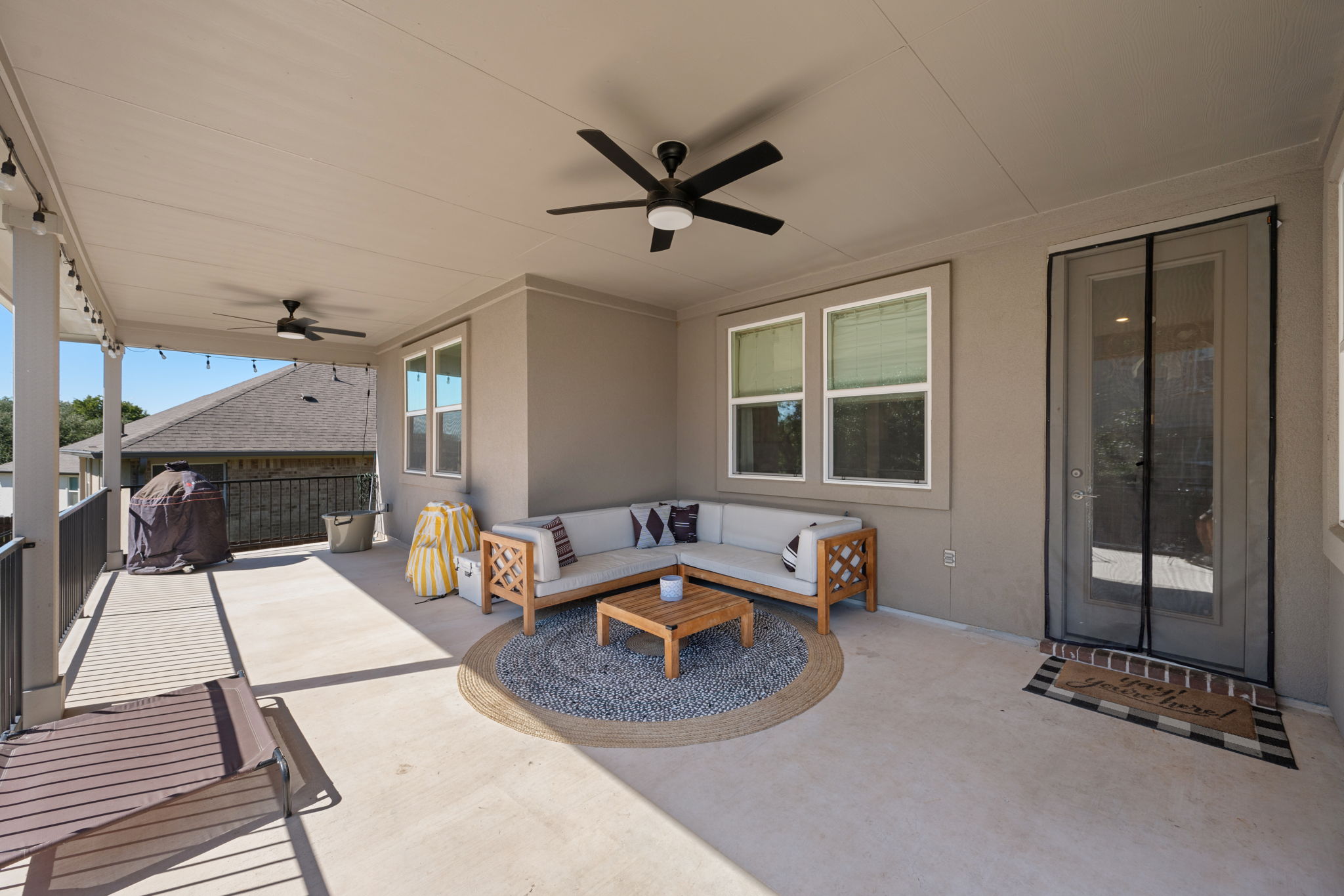 1808 Weavers Bend Georgetown, TX 78628 - Photo 24 of 30 a living room with furniture a fireplace and a floor to ceiling window