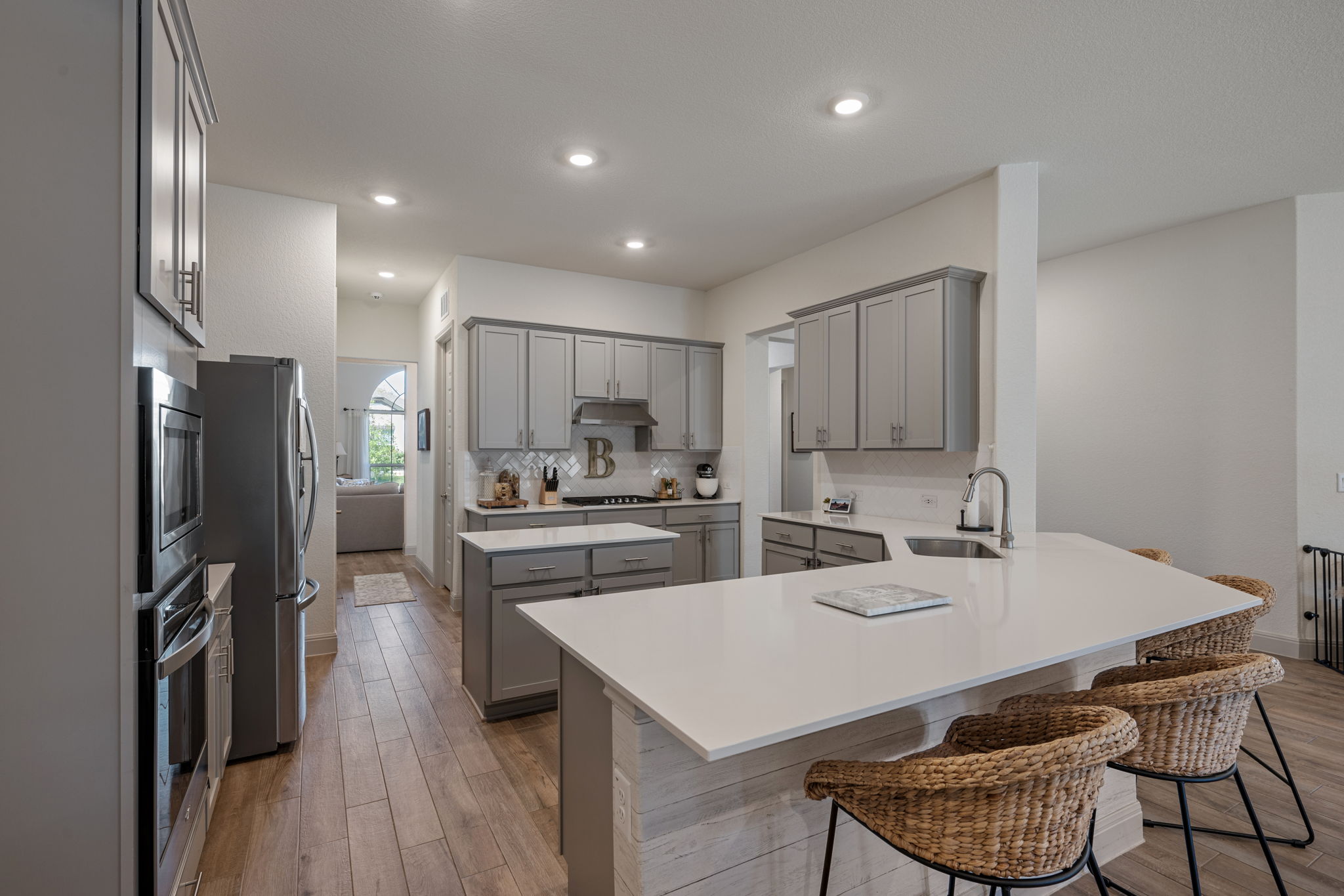 1808 Weavers Bend Georgetown, TX 78628 - Photo 9 of 30 a kitchen with a dining table chairs refrigerator and microwave