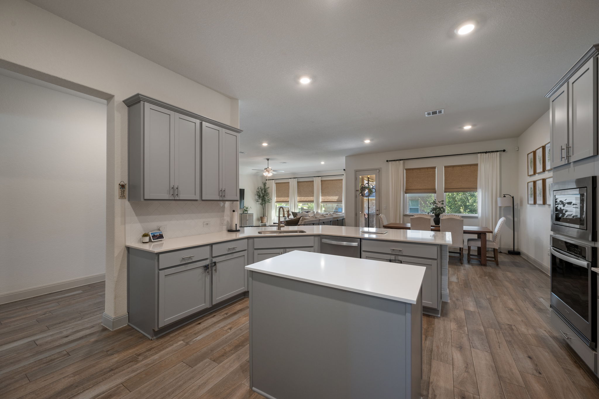 1808 Weavers Bend Georgetown, TX 78628 - Photo 10 of 30 a kitchen with a sink cabinets and wooden floor