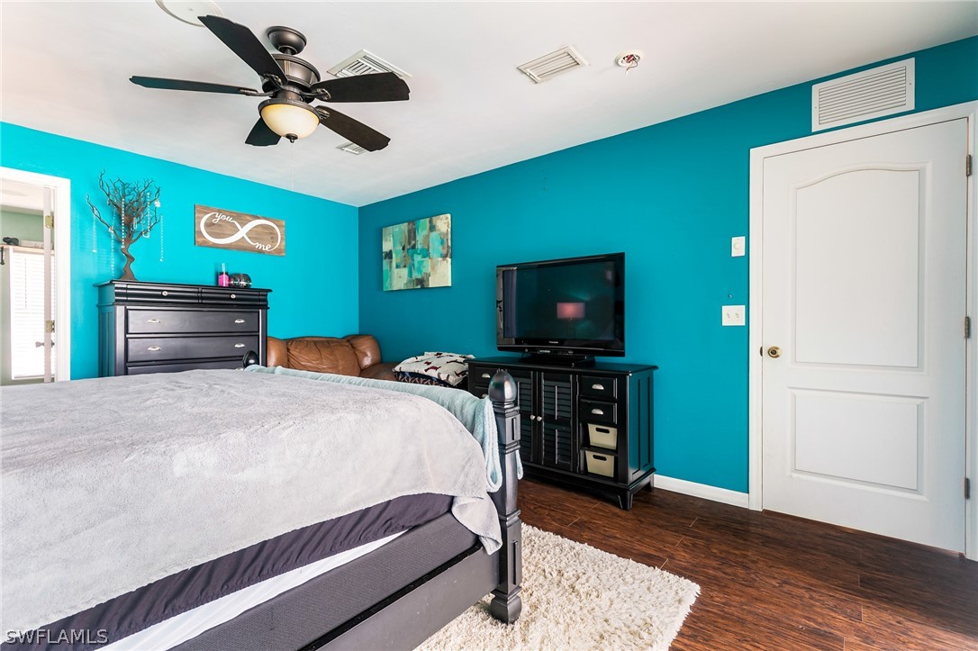 17557 Ingram Road Fort Myers, FL 33967 - Photo 15 of 29 a bedroom with a bed and a flat screen tv