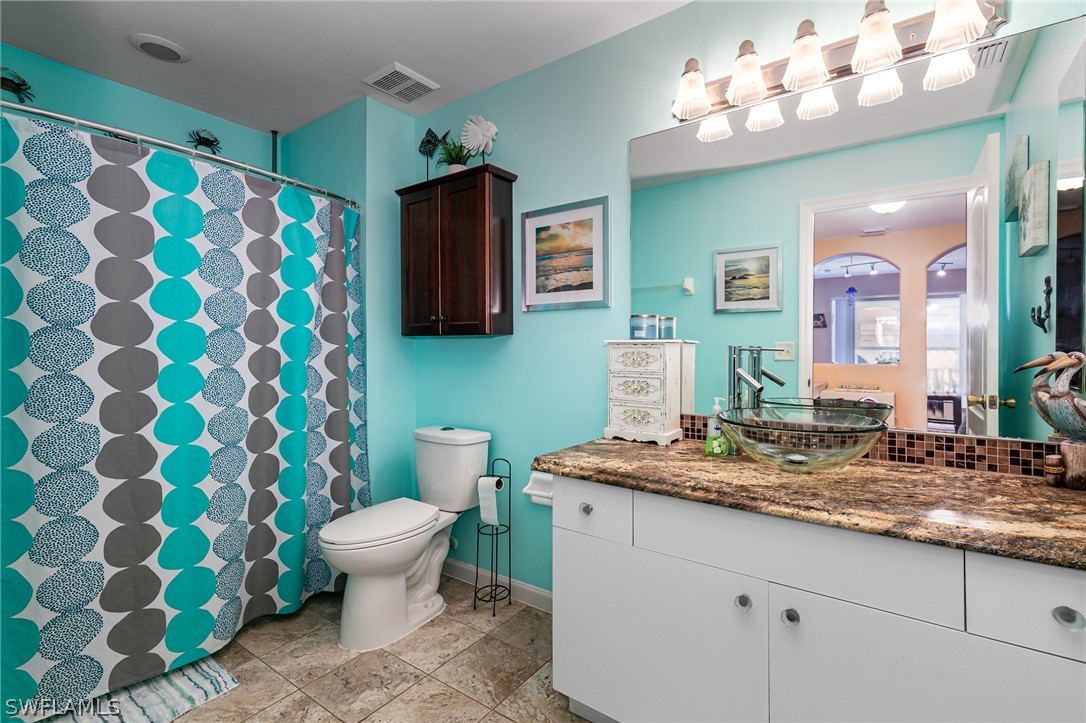 17557 Ingram Road Fort Myers, FL 33967 - Photo 23 of 29 a bathroom with a sink mirror and toilet
