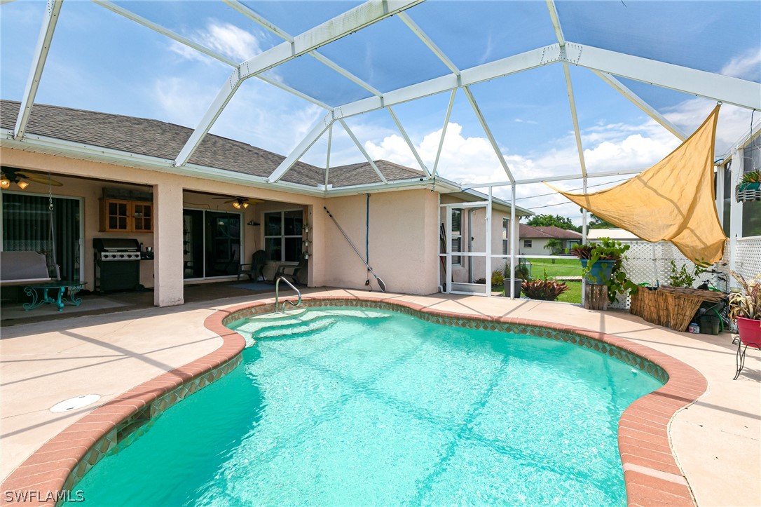 17557 Ingram Road Fort Myers, FL 33967 - Photo 26 of 29 a view of pool with lawn chairs under an umbrella