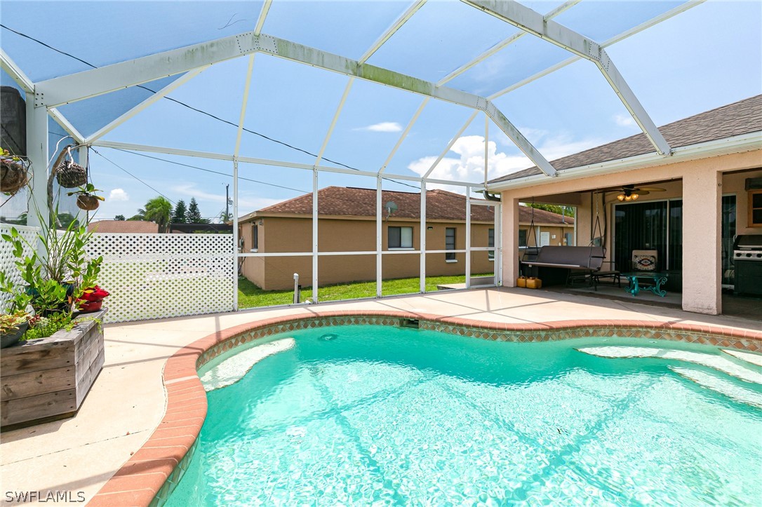 17557 Ingram Road Fort Myers, FL 33967 - Photo 27 of 29 a view of a house with a swimming pool and a yard