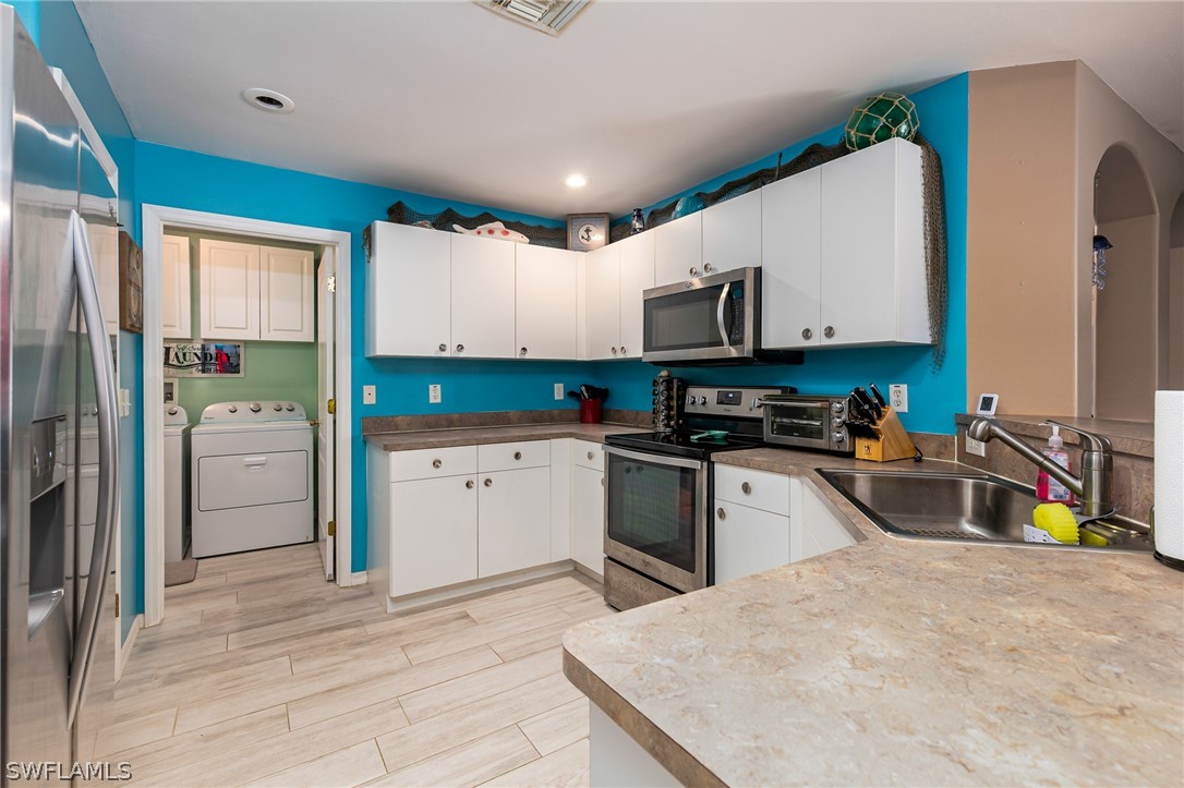 17557 Ingram Road Fort Myers, FL 33967 - Photo 8 of 29 a kitchen with a sink a counter top space stainless steel appliances and a window