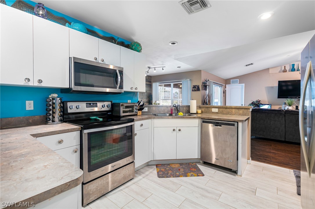 17557 Ingram Road Fort Myers, FL 33967 - Photo 9 of 29 a kitchen with stainless steel appliances granite countertop a stove a sink and a microwave