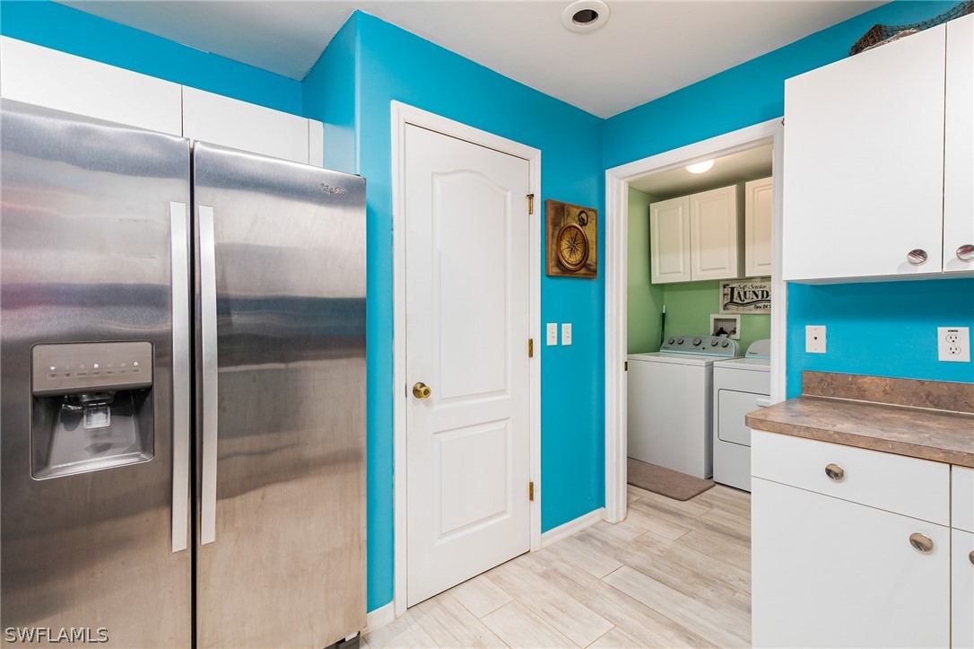 17557 Ingram Road Fort Myers, FL 33967 - Photo 10 of 29 a kitchen with a refrigerator and cabinets