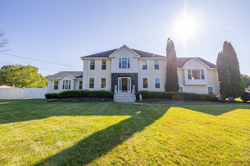 a front view of a house with swimming pool having outdoor seating