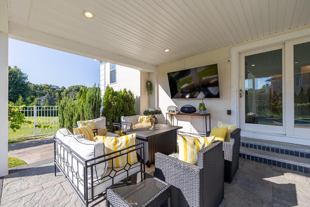 2 Nollet Drive Andover, MA 01810 - Photo 3 of 9 a living room with fireplace furniture and a flat screen tv