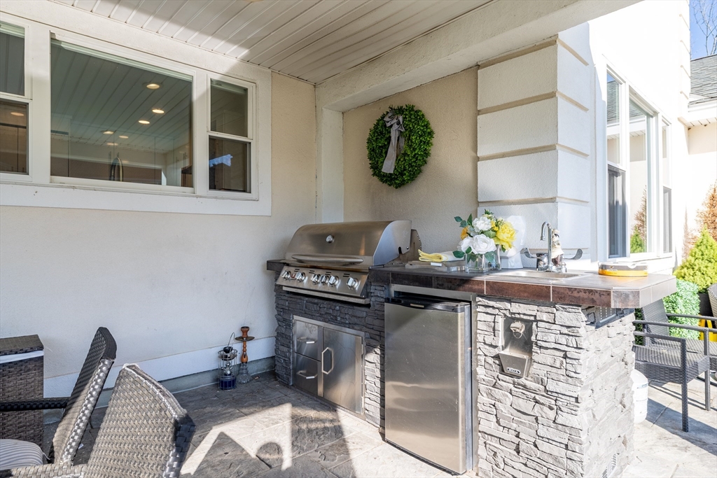 2 Nollet Drive Andover, MA 01810 - Photo 4 of 9 a kitchen with stainless steel appliances granite countertop a sink and a stove next to a window