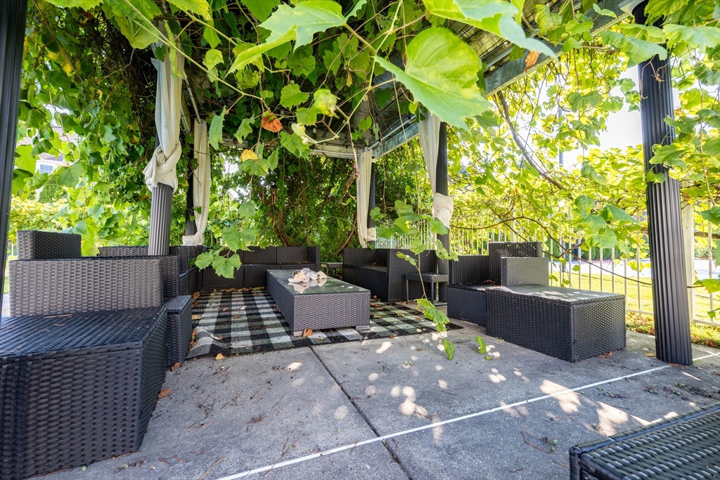 2 Nollet Drive Andover, MA 01810 - Photo 8 of 9 a view of a patio with table and chairs and potted plants