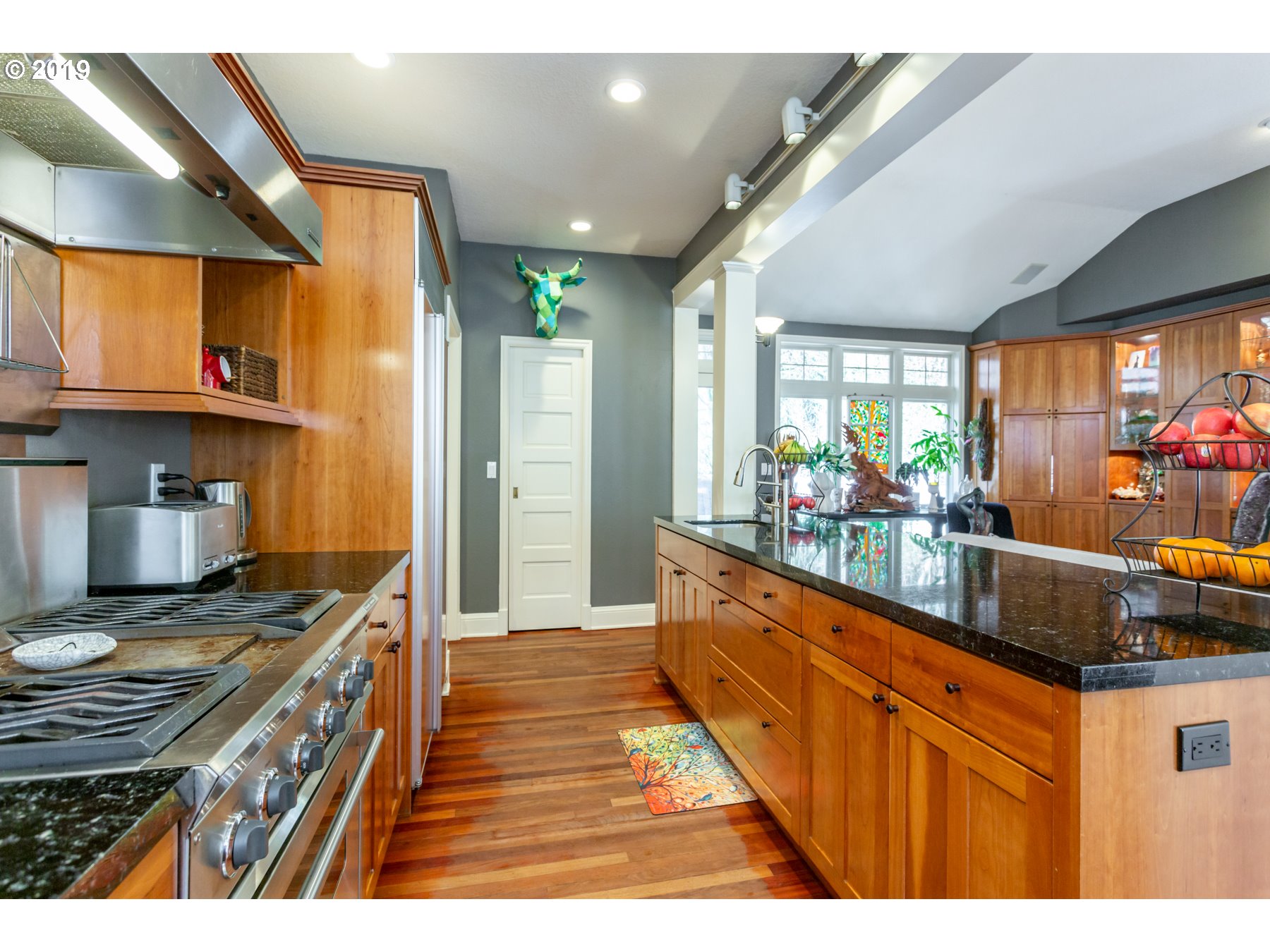 731 Southwest Bancroft Terrace Portland, OR 97239 - Photo 5 of 46 a kitchen with stainless steel appliances granite countertop a stove a sink and a wooden cabinets