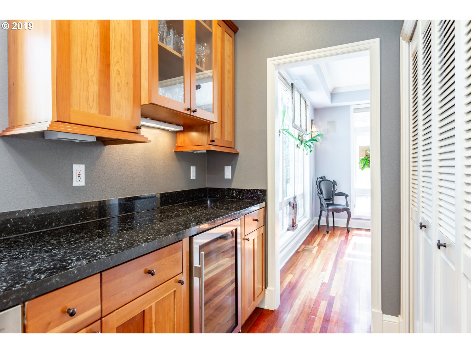 731 Southwest Bancroft Terrace Portland, OR 97239 - Photo 8 of 46 a kitchen with granite countertop wooden cabinets a granite counter tops and a view of living room