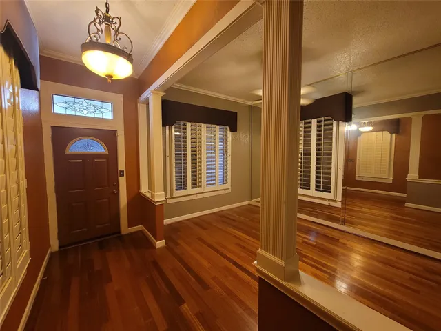 a view of a room with wooden floor and windows