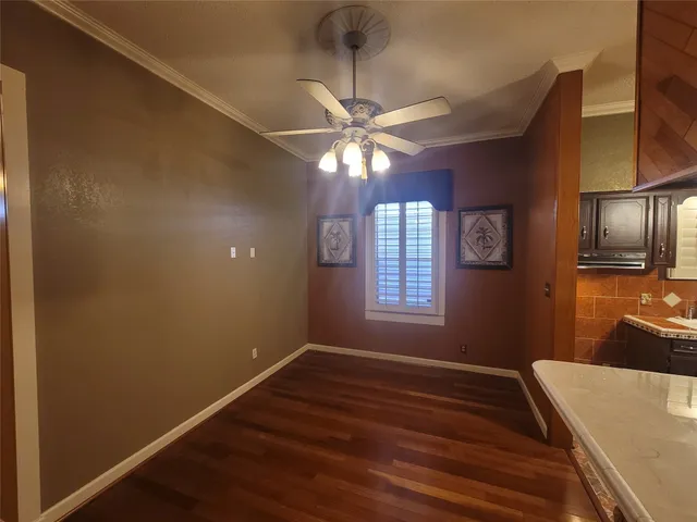 a view of a livingroom with a window and wooden floor
