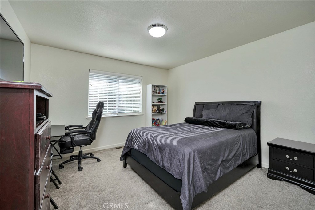 18230 Hidden Valley Road Hidden Valley Lake, CA 95467 - Photo 14 of 22 a bedroom with a bed and a desk