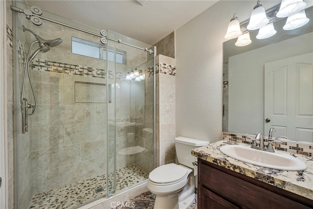 18230 Hidden Valley Road Hidden Valley Lake, CA 95467 - Photo 16 of 22 a bathroom with a granite countertop sink toilet and shower