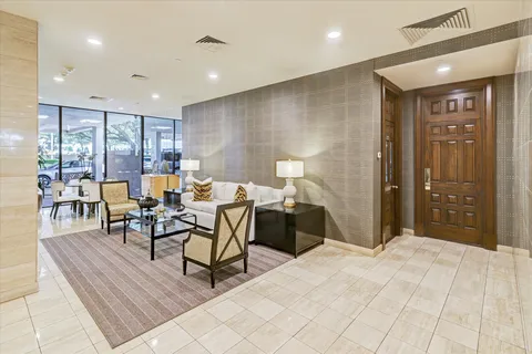 a view of a hallway with wooden floor and furniture