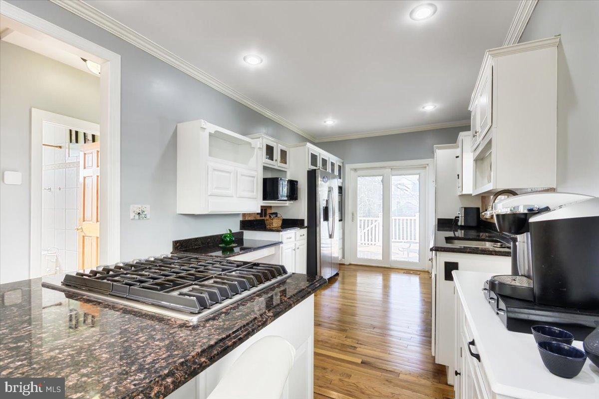 5306 Morello Road Baltimore, MD 21214 - Photo 11 of 37 a kitchen with kitchen island a counter top space a sink stainless steel appliances and cabinets