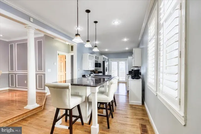 a view of a dining room with furniture window and wooden floor
