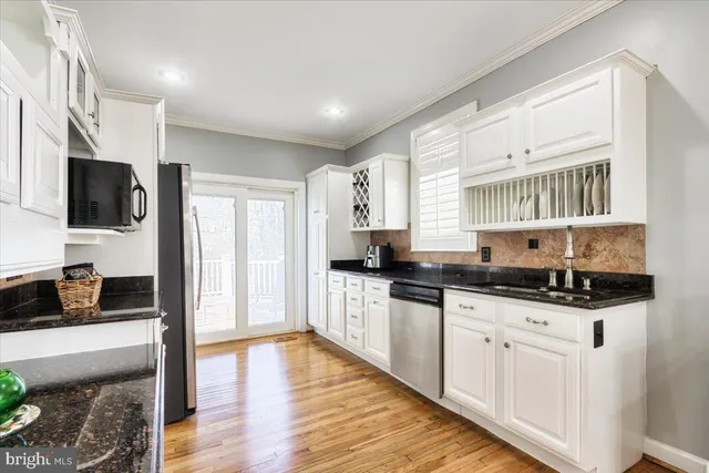 a kitchen with granite countertop a sink and cabinets