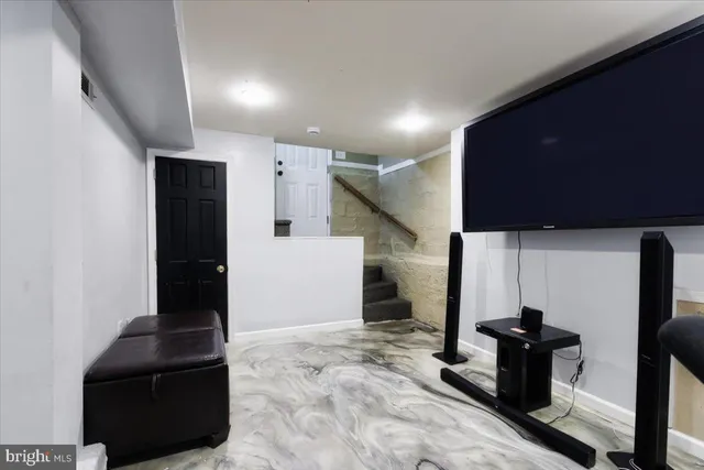 a view of a livingroom with furniture and staircase