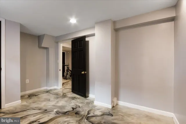 a spacious bedroom with a bed a window and couch