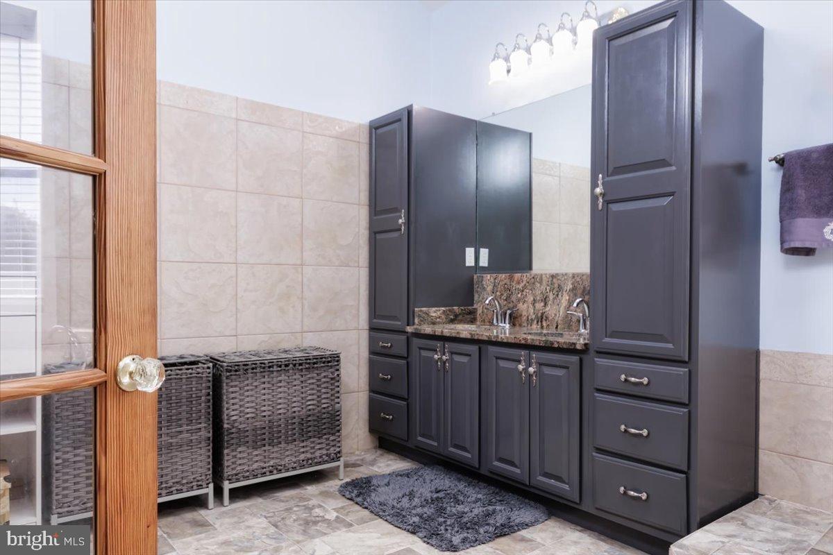 5306 Morello Road Baltimore, MD 21214 - Photo 30 of 37 a bathroom with a granite countertop sink and a mirror