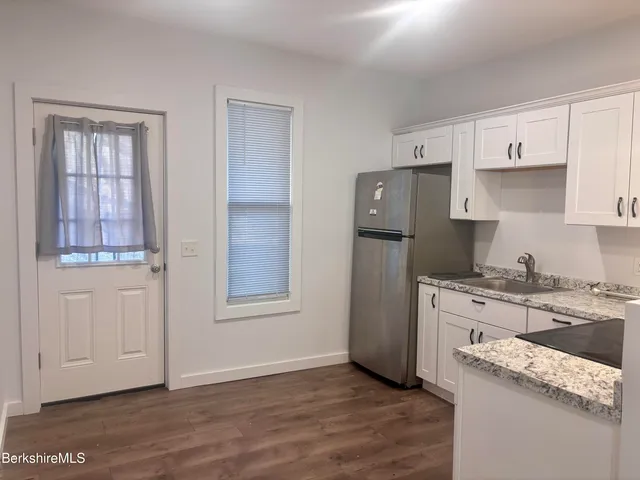 a kitchen with stainless steel appliances granite countertop a stove and a refrigerator